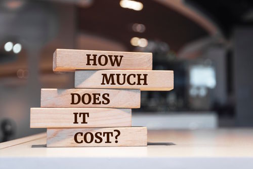 Wooden blocks displaying the question how much does it cost representing pricing transparency