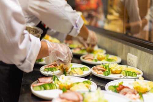 Chefs in a professional hospitality kitchen preparing meals, symbolizing hospitality jobs, inclusive recruitment, and workforce development.